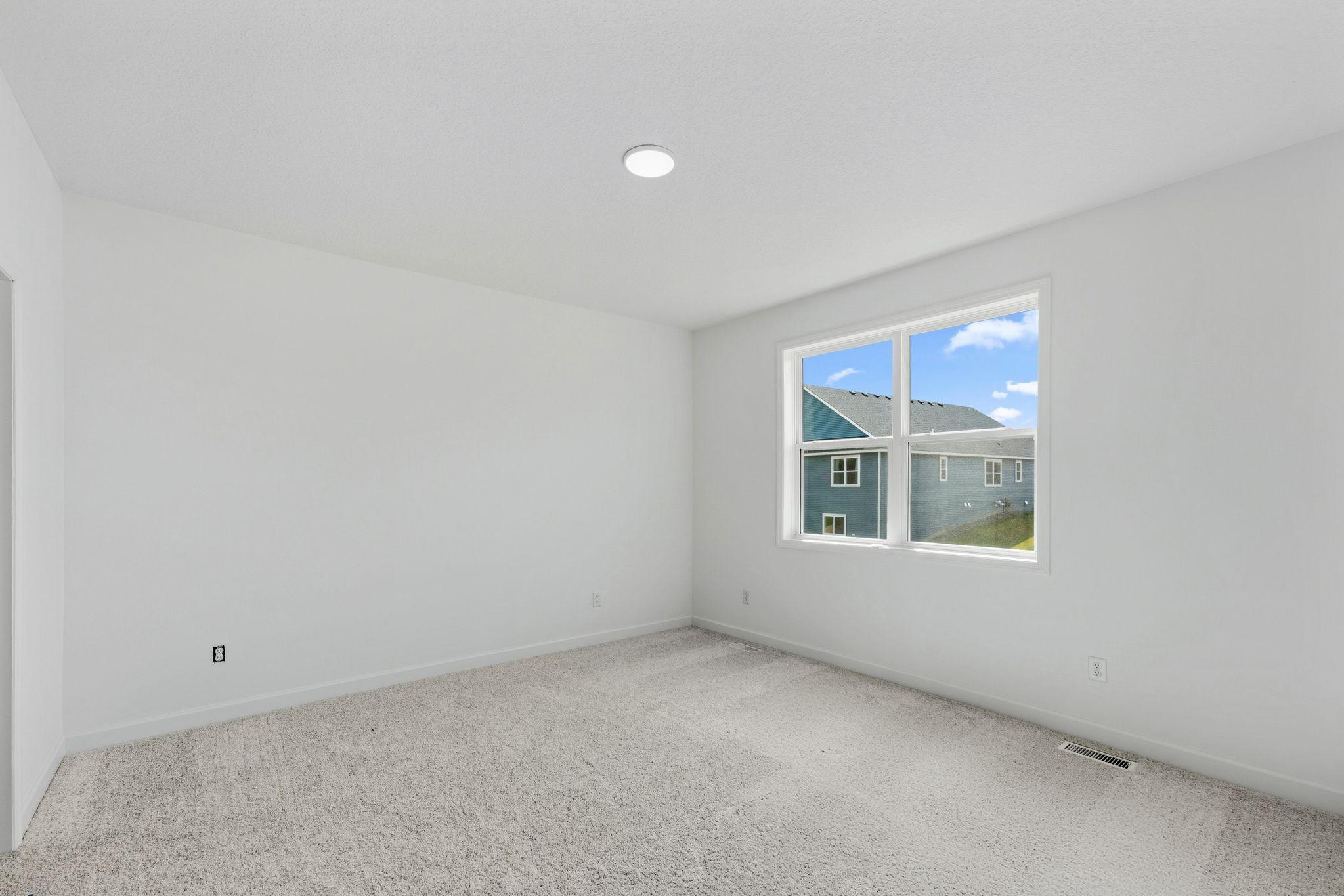 Made for rest and relaxation, the owner’s suite features a luxe bathroom and a walk-in closet.