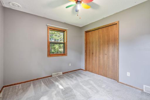 Classic wood trim and closet doors add warmth and character to this bedroom.