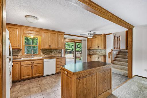 Warm wood cabinetry, a center island and generous workspace make this kitchen ready for everyday meals and entertaining.
