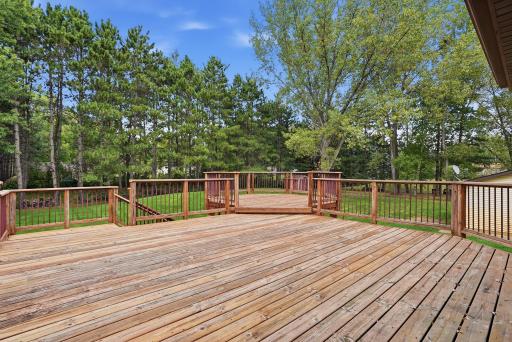 Enjoy the peaceful surroundings from this expansive deck overlooking the sprawling backyard!