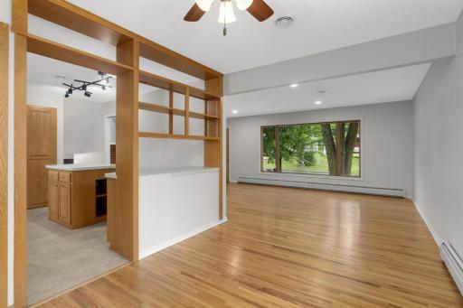 Dining room is open to the kitchen with midcentury modern shelving