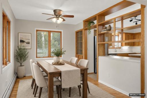 Dining room with ceiling fan (virtually staged)