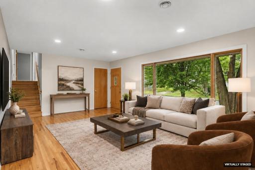 Another angle of the living room and main entrance (virtually staged)