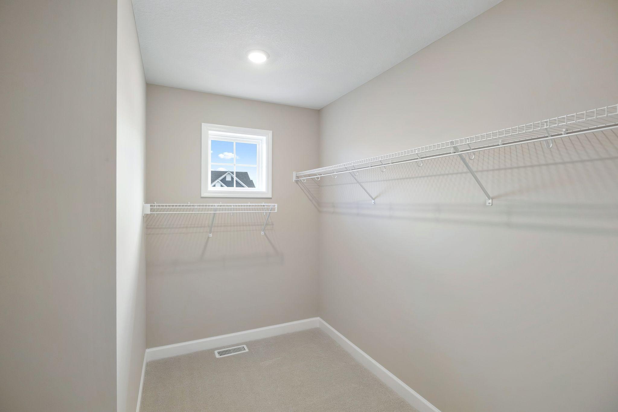 The walk-in closet offers ample space and storage