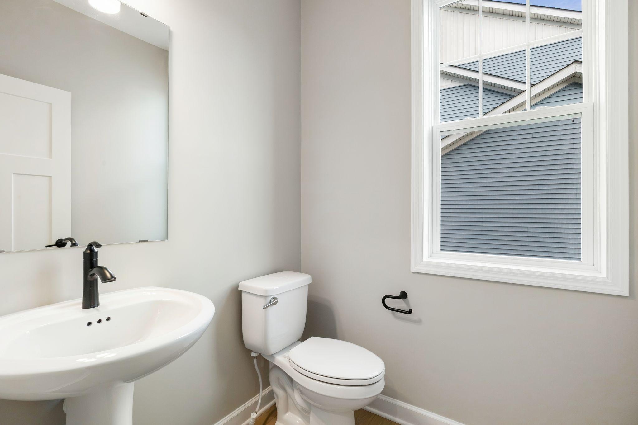 Conveniently placed near the Great Room, the powder room is conveniently trucked away with privacy in mind.