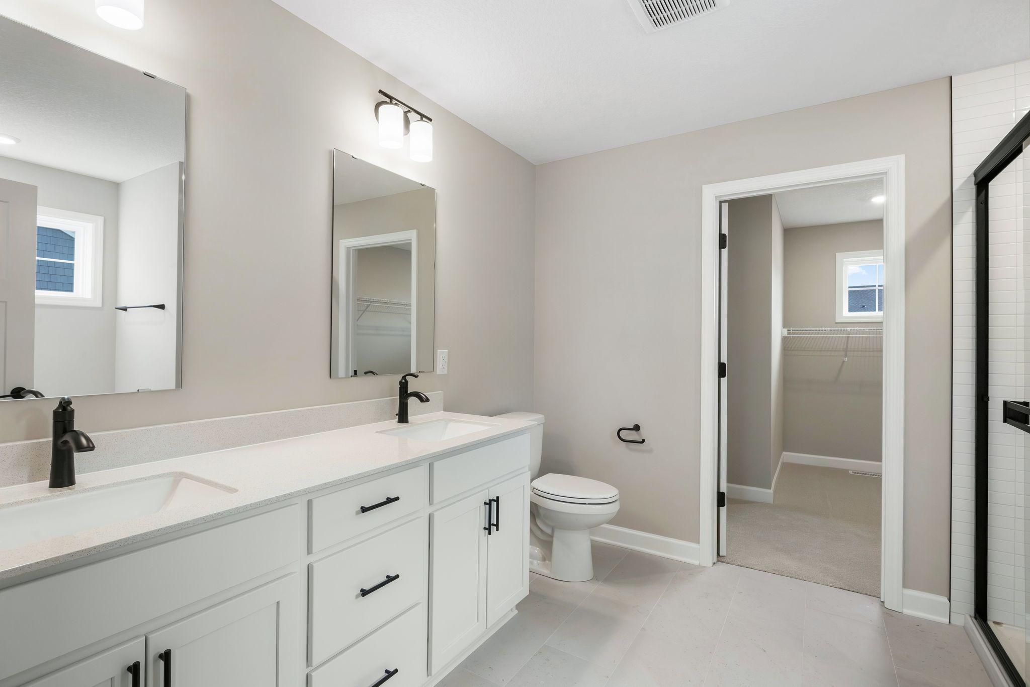 The en-suite bathroom has dual sinks to simplify any morning routine