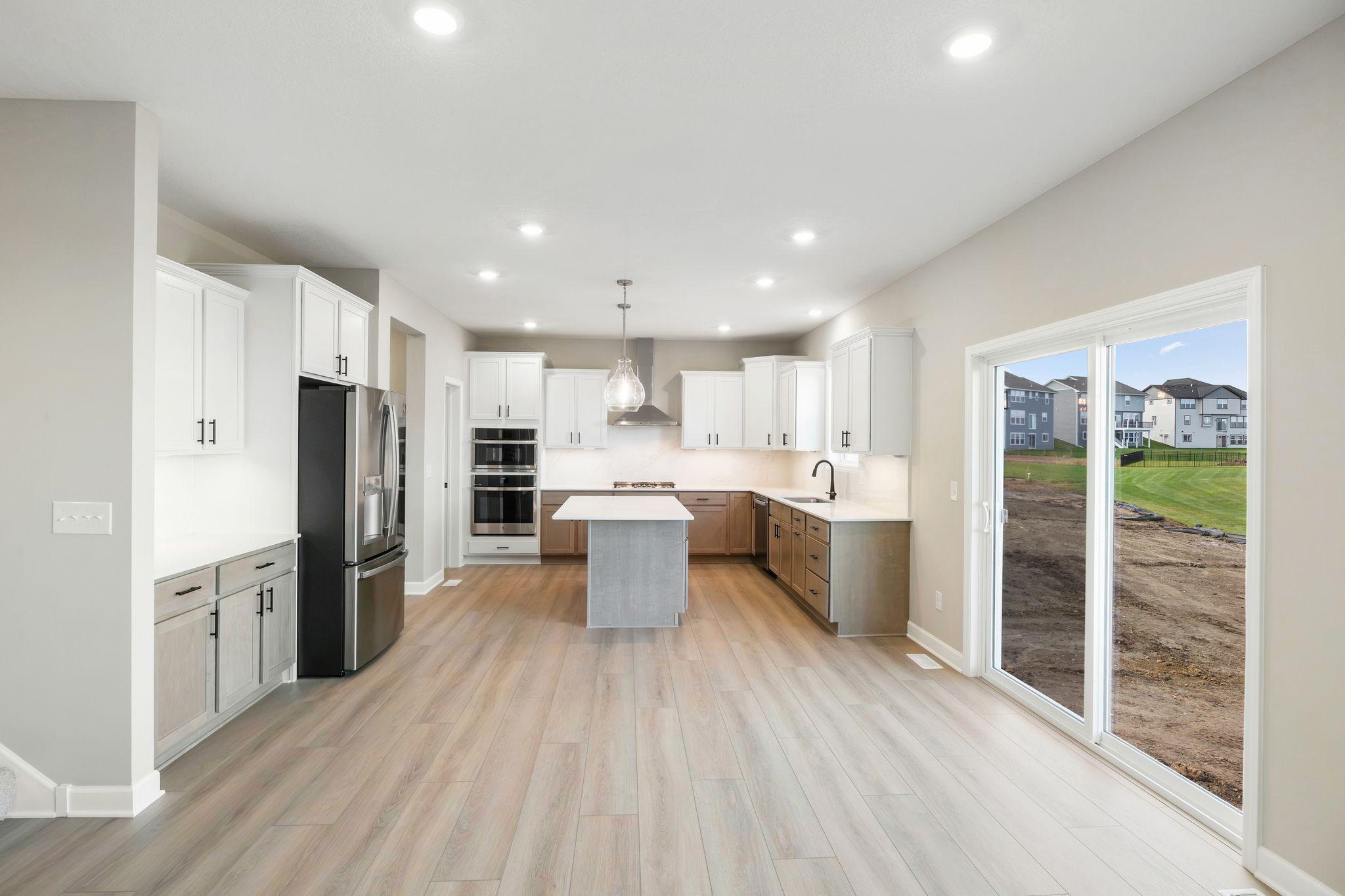The kitchen has ease-of-access to the mudroom and flows seamlessly into the dining room