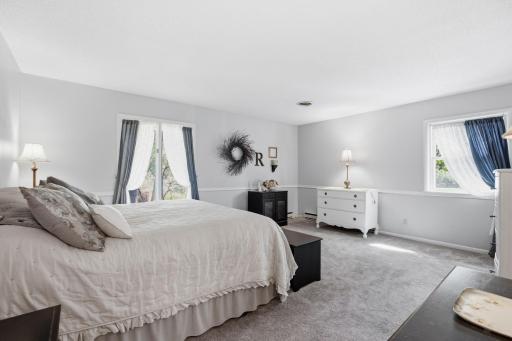 The spacious primary bedroom offers more natural lighting and a private ensuite.