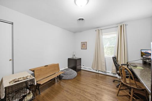The third bedroom on the main level offers more hardwood floors and a built-in desk area perfect for those who work from home!