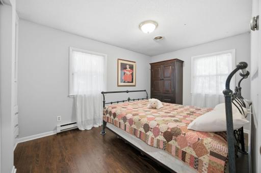 The second main level bedroom is spacious and has gorgeous hardwood floors.