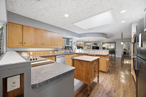 The kitchen is centralized and open and offers stunning natural light through the skylights.