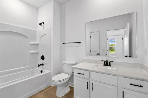 This shared full bathroom is easily accessible from the open floorplan for guest and daytime use.