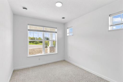 A secondary bedroom situated off the foyer works well as a space for overnight guests or a home office