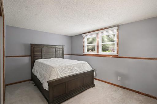 Upper level bedroom with hardwood floors and fresh paint