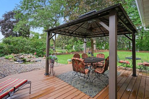 Maintenance Free deck with heavy duty pergola that has a fan and lights. The serene backyard will relax your mind. Enjoy a bonfire pit, and irrigation to keep grass nice and lush.