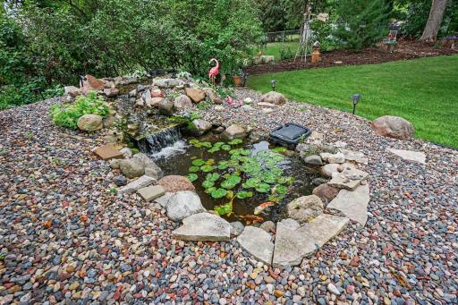 Beautiful waterfall leads to filtered Koi pond. Solar lights and stunning landscaping surround the tranquil pond