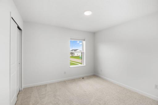 This bedroom is conveniently steps away from the full-sized bathroom and tech space on the second level.