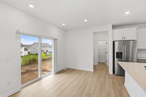 The dining room features large glass sliders to bathe the space in natural light, perfect for meals at all times of day and night.