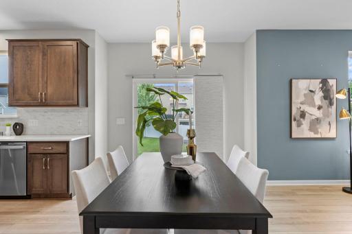 The dining area offers plenty of room for a large table and sits conveniently between the kitchen and living room. Sliding doors provide easy access to the backyard.