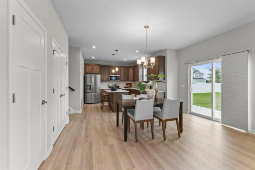 Spacious dining area flows directly into the kitchen for easy everyday living and entertaining. Hard-surface flooring continues throughout the open main living spaces.