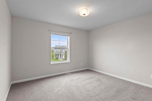 Another generously sized secondary bedroom with great natural light and plenty of room for bedroom furniture, guests, or a home office setup.