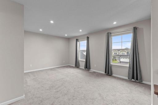 The versatile upper-level loft adds valuable extra living space and can easily serve as a second family room, playroom, home office, entertainment area, or converted to a 4th upper bedroom.