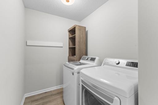 No carrying laundry up and down the stairs! The conveniently located upper-level laundry room includes the washer and dryer and offers additional room for storage.