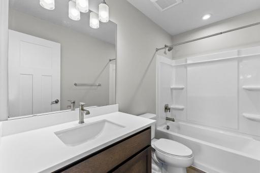 The upper-level full bathroom features a modern fixtures and a tub/shower combination.