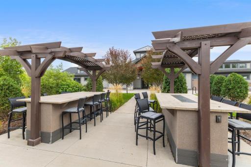 Multiple pergola-covered gathering spaces provide plenty of seating and inviting areas to enjoy time outdoors with family, friends, and neighbors.