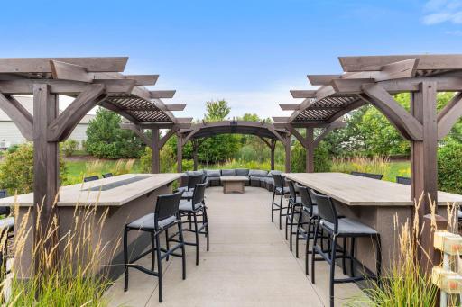 Enjoy this impressive covered outdoor gathering space featuring a beautiful stone fireplaceâperfect for relaxing and connecting with neighbors.