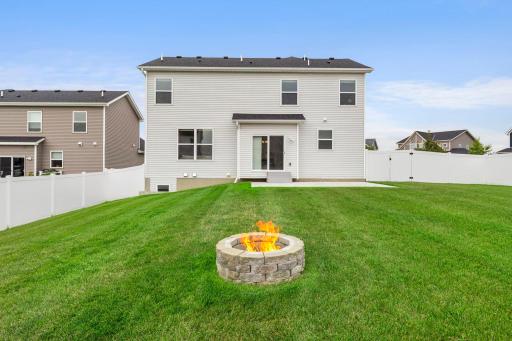 Gather around the built-in fire pit for summer evenings and cool fall nights. The large fenced yard offers plenty of space beyond the fire pit for recreation and entertaining.