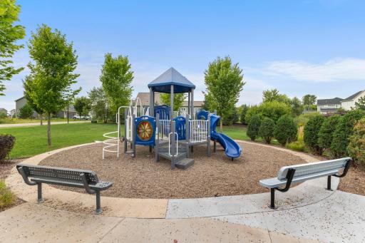 Another view of the neighborhood playground and surrounding green space, offering a convenient outdoor recreation area within the community.