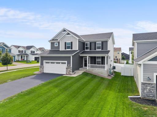 Another great view of this beautiful Avonlea home, showcasing the attractive exterior, covered front porch, manicured lawn, and welcoming neighborhood setting.
