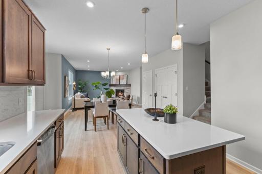 From the kitchen, enjoy a clear view through the dining area and into the living room and fireplace. The open layout makes this main level ideal for gathering and entertaining.