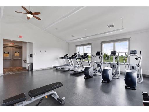 nother view of the community fitness center, offering multiple treadmills, elliptical machines, exercise equipment, and a bright, spacious setting for staying active.