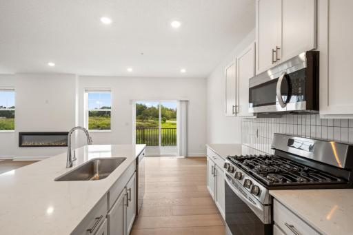 (Photo of an inventory home, actual homes finishes will vary) Thoughtfully-designed, modern, and fresh describe this kitchen.
