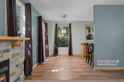 Light pours into the informal dining area, finished with a beautiful light fixture.
