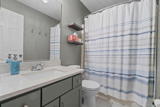 The second full bathroom is right where you need it, centrally located near the bedrooms with additional hall storage. Both upper-level bathrooms have been refreshed with quartz countertops and new showerheads.