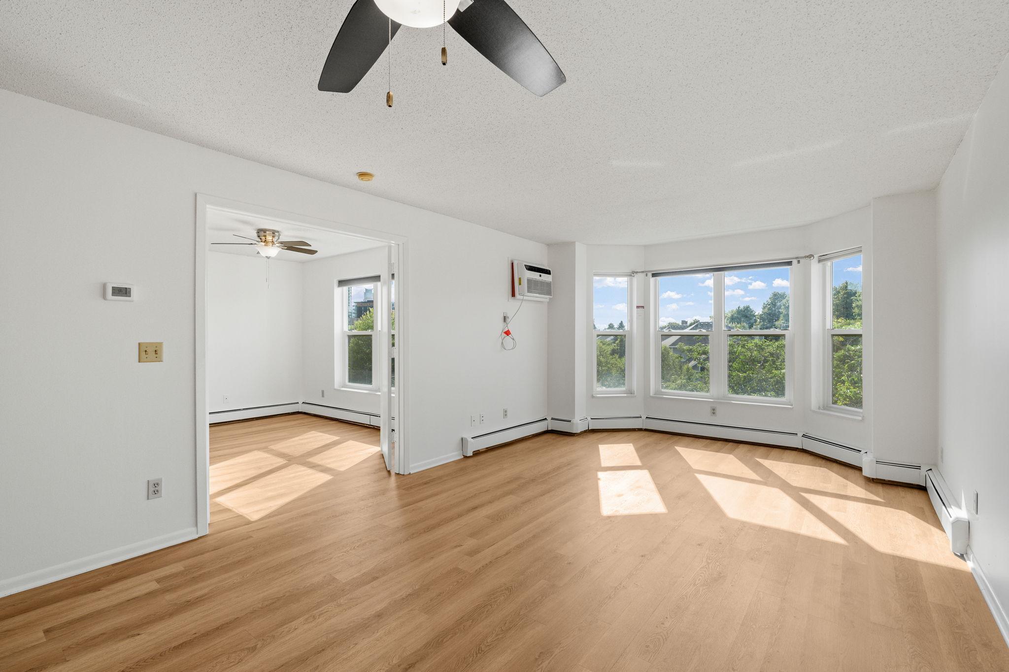 Attractive living room with newer flooring & freshly professionally painted. Loads of natural lighting with beautiful views