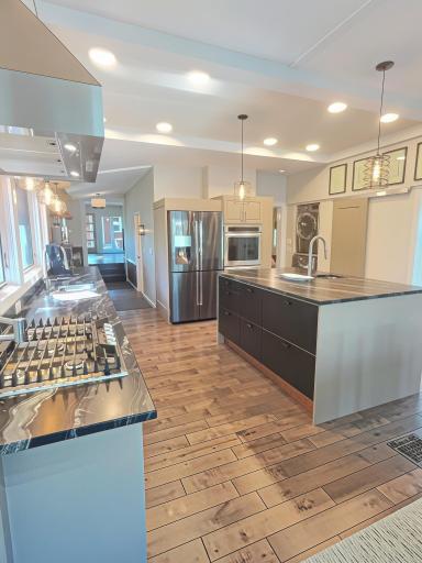A look at the kitchen, perfect for the Happy Chef. All stainless-steel appliances including a French door refrigerator-freezer, double convection oven, dishwasher, countertop gas cooktop with high powered hood vent and pot filler.