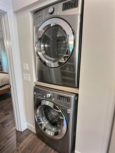 Located in a cove in the kitchen are front load stackable washer and dryer. Close to the bedroom so you don't have to haul laundry all over. Next to the washer is a conveniently located pantry, hidden behind a barn door.