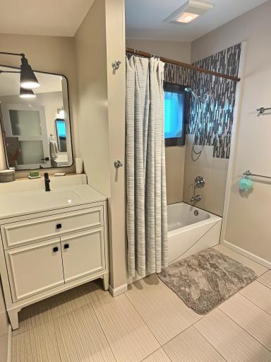 Attached primary bathroom has two vanities, jetted tub and shower.
