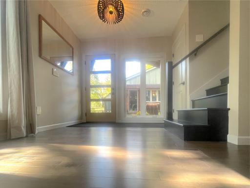 The main entryway offers light and sunshine through the floor to ceiling windows.
