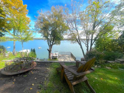 Looking down onto the 60 feet of lake shore and the panoramic view of Cedar Lake. Take advantage of the boat house for storing all the lake toys as well as a seating area with a close-up view of the lake.