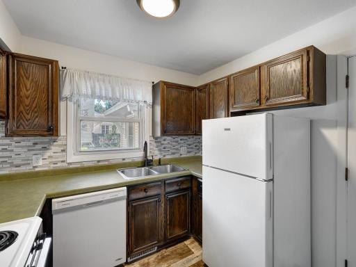 This functional kitchen has a window that overlooks the patio area.