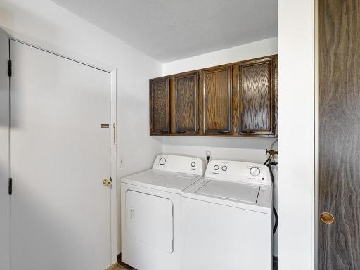 The laundry area is conveniently located in the kitchen.
