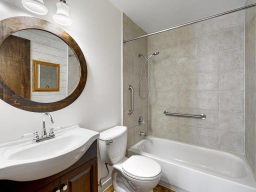 The full bathroom has a newer ceramic shower.