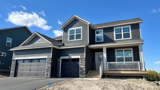 Charming two-story with front porch entry, situated on a walkout homesite. Irrigation, sod, trees and landscape included.