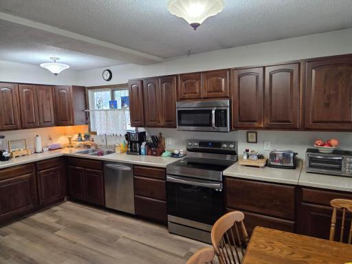 Updated eat in Kitchen with newer appliances. Beam is where wall was removed to expand kitchen.