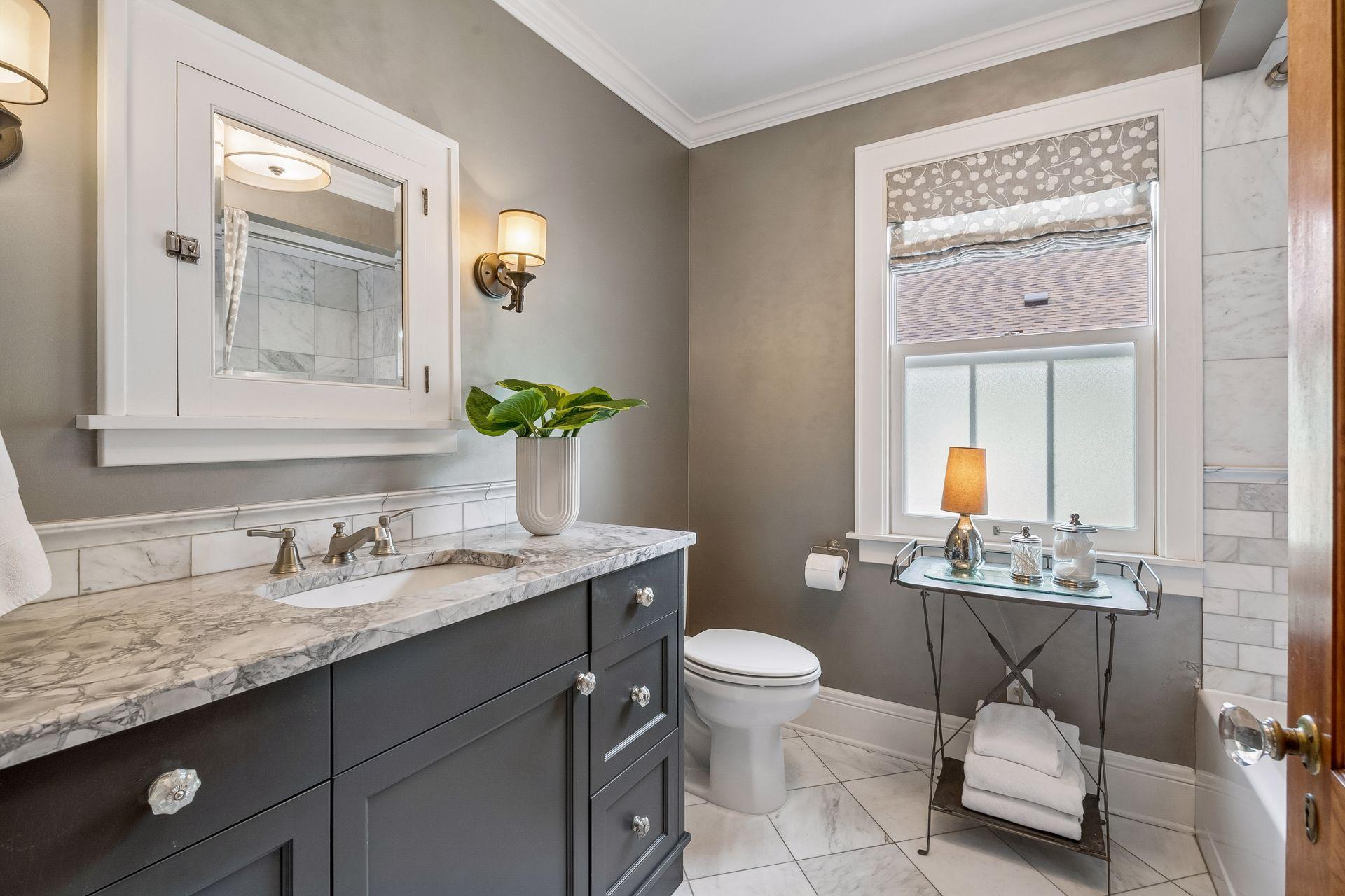 The remodeled 2nd floor bathroom features stone countertop and heated floors.
